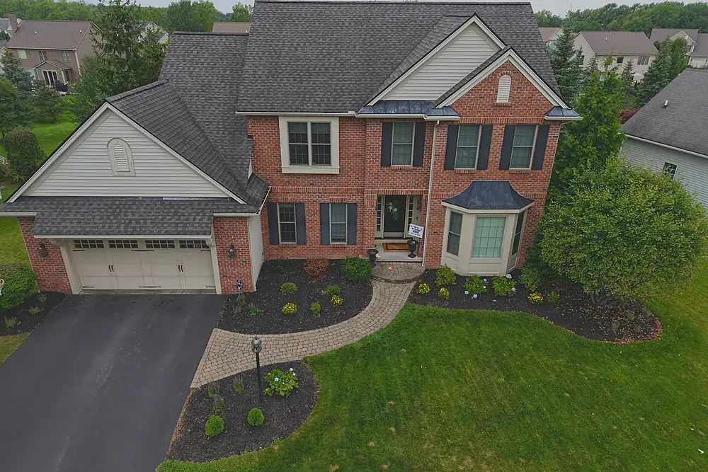 Aerial photograph of a brick colonial home in a Rochester, New York suburb