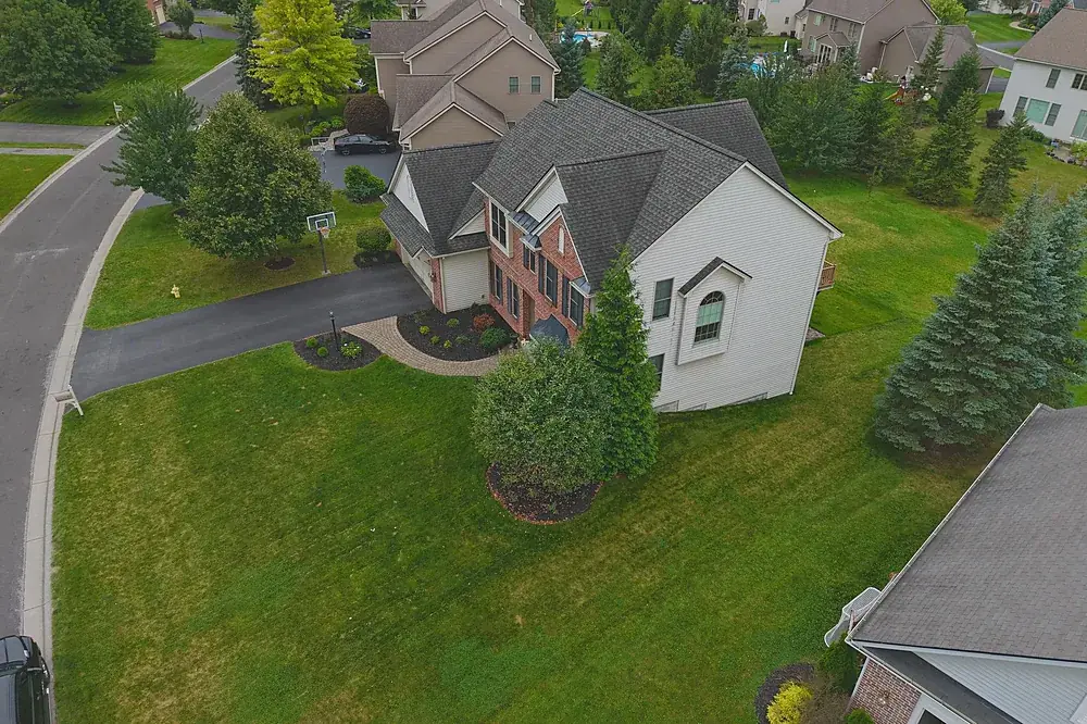 Aerial photo of a colonial home with a curved driveway, supplied unbranded for a partner's listing