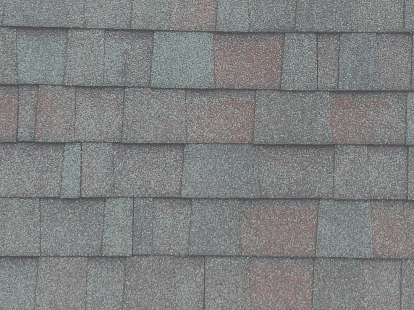 Close-up drone photo of asphalt shingle surface condition on a residential roof
