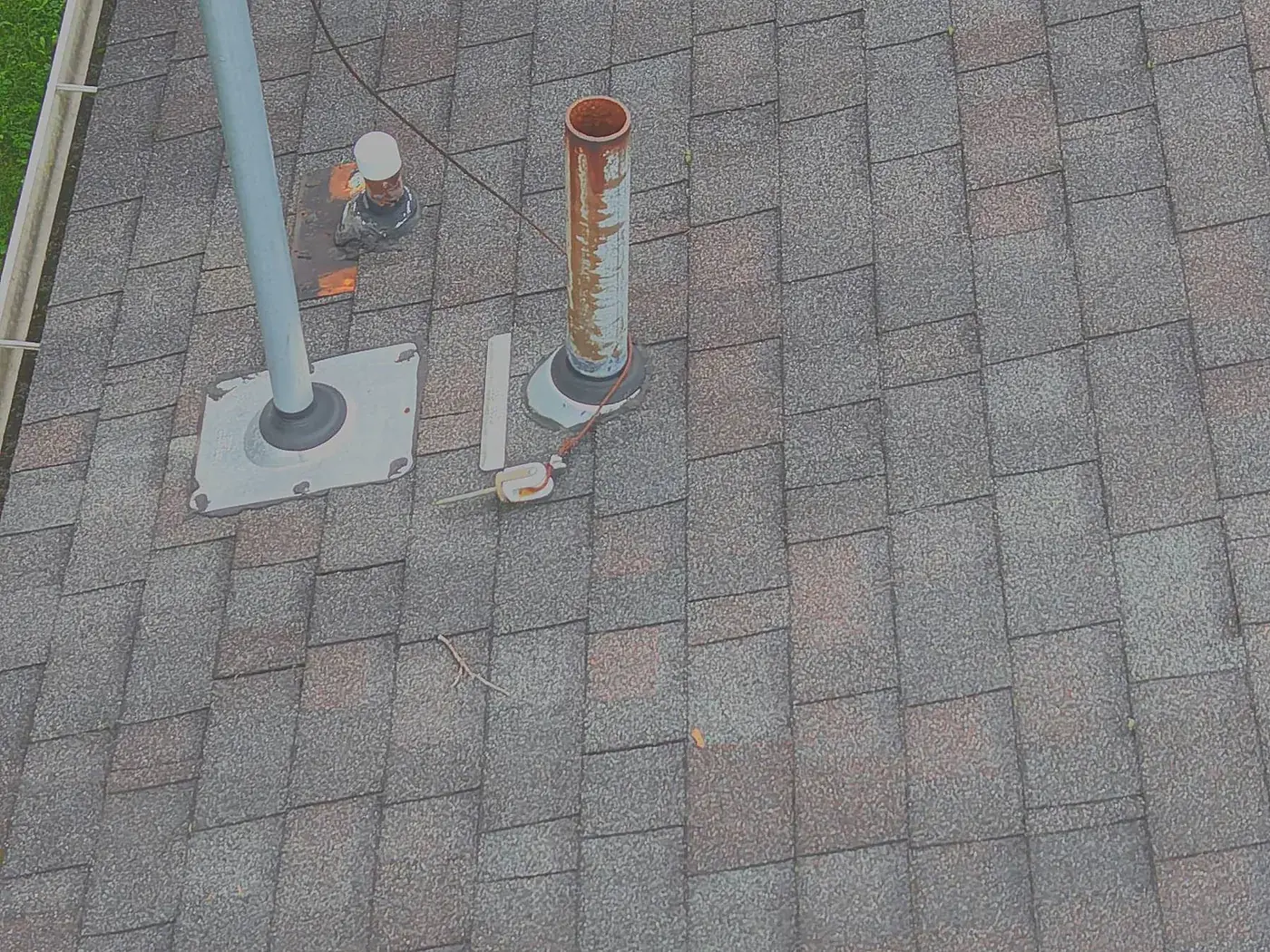 Drone photograph of vent boot and flashing detail on an asphalt shingle roof