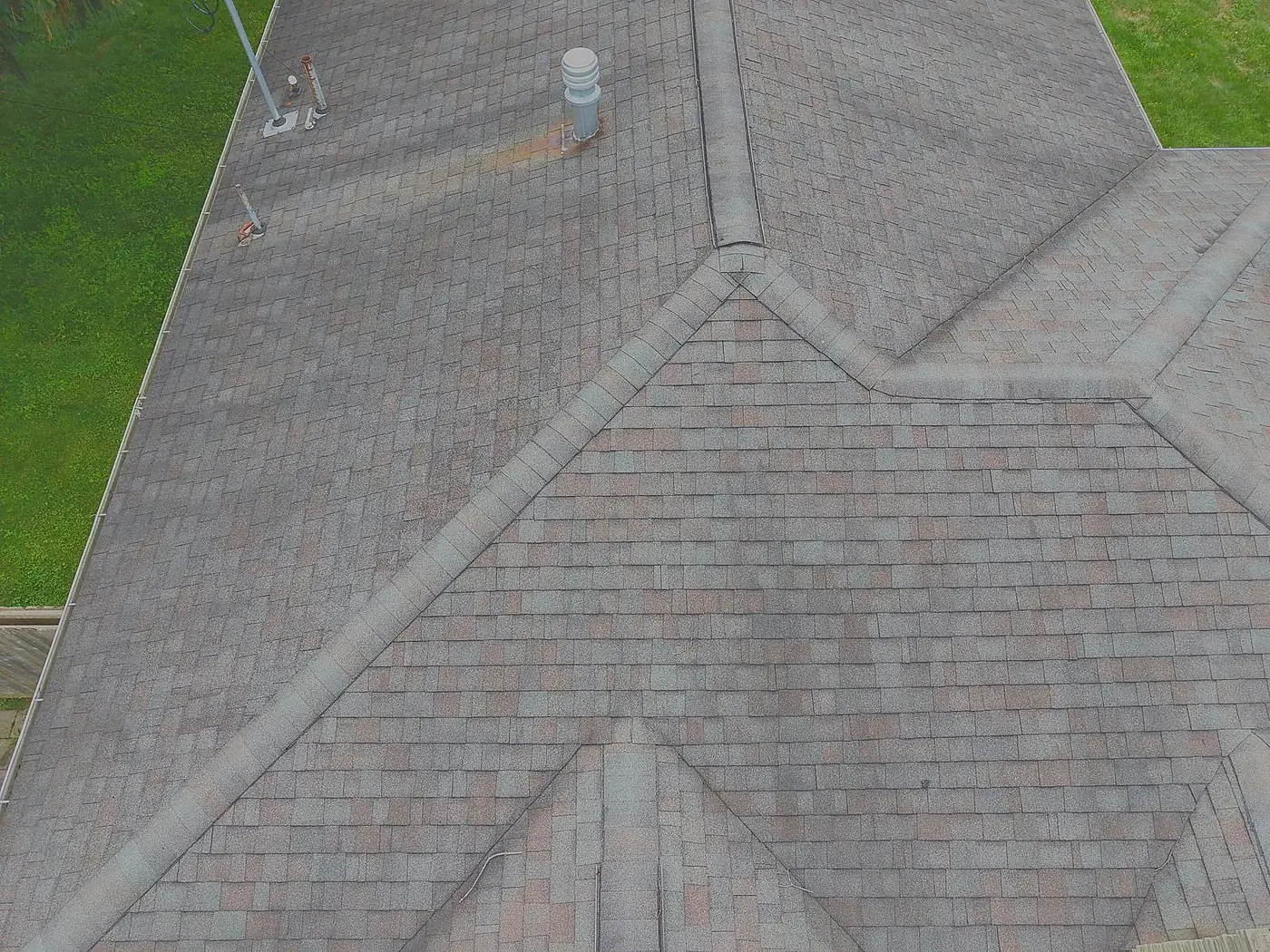 Close-up drone photograph of ridge and hip cap shingles on a residential roof