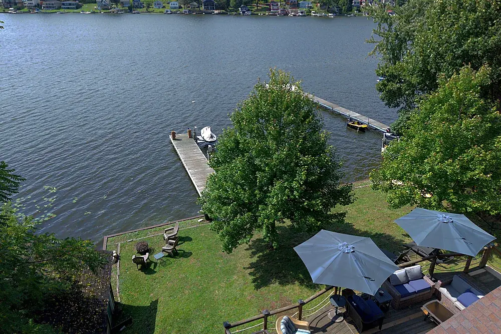 Aerial view of a short-term rental waterfront deck, private dock and lake near Rochester, New York