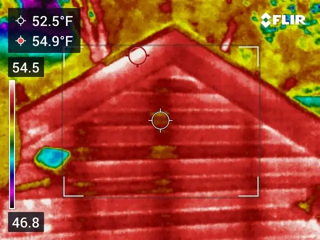 Thermal image of a sided gable wall at night showing the wall studs and roof edge as a pattern