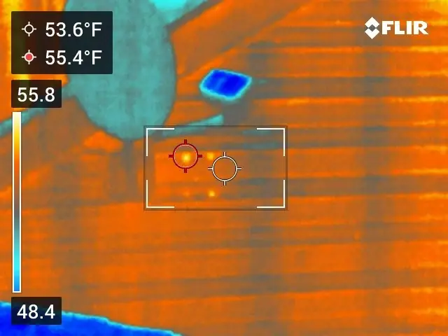 Thermal image of vinyl siding with a small warm spot near a wall vent